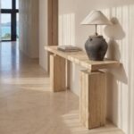 Casa Square Leg Console in natural reclaimed elm with substantial block legs and waxed timber finish, styled with a ceramic lamp and books in a contemporary hallway.