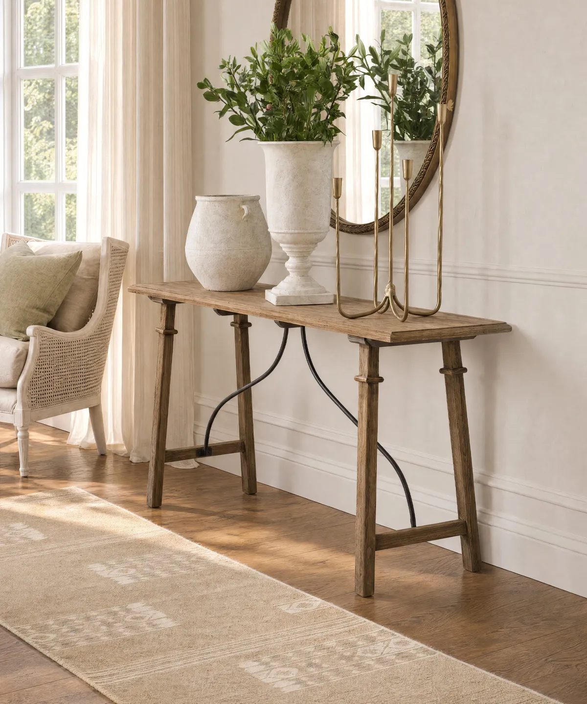Alba Oak Console Table – Natural Alba Oak Console Table in natural timber with a slender rectangular top and elegant curved metal detailing, styled in a warm, neutral interior.